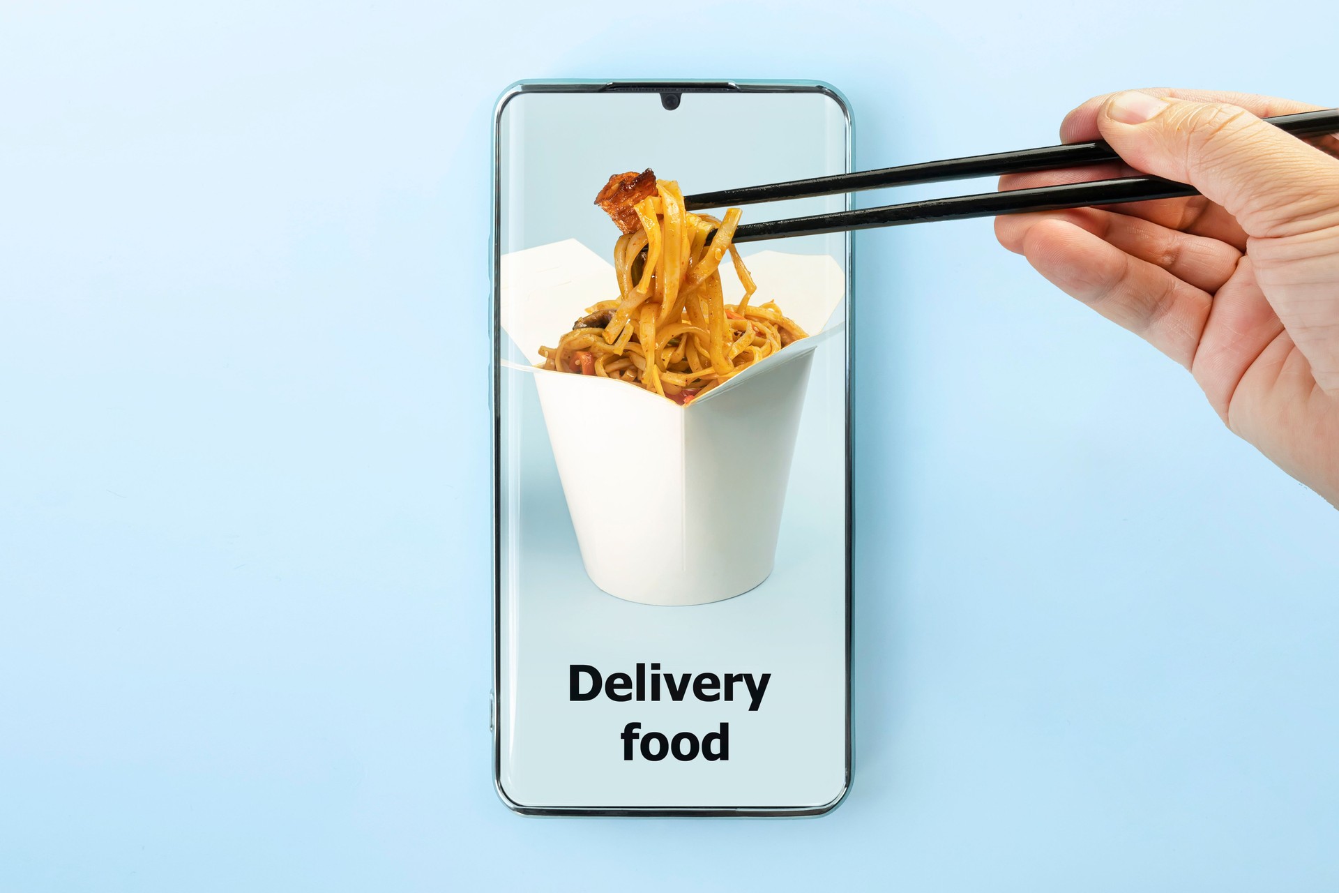 fast food and fast delivery when ordering online concept. Order and deliver food online. Eat from smartphone. Gadget on blue background. order meal in a restaurant using the app on your mobile phone.